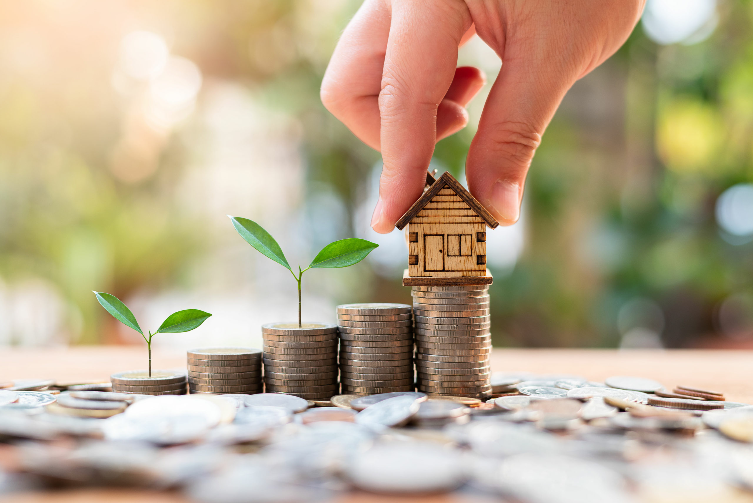 house model on money coins saving for concept investment mortgag