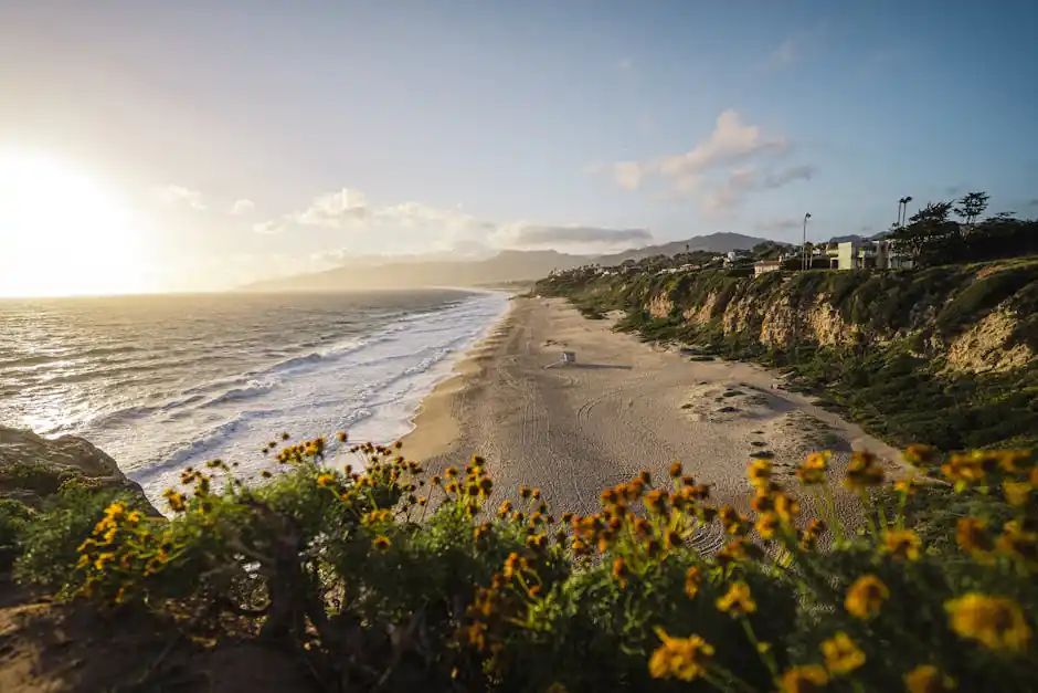 Captivating view of Malibu beach at sunset with waves and cliffs in California, USA.